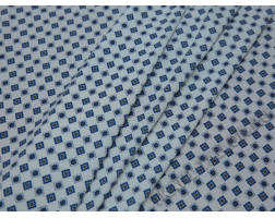 Трикотажная ткань белая с синим орнаментом